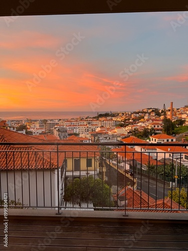 Vibrant orange sunset sky over Funchal rooftops, Madeira
