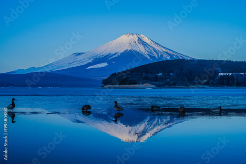 Tableau sur toile Majestic Mount Fuji at sunset reflected in the calm waters of Lake Yamanaka, Yamanashi, Japan