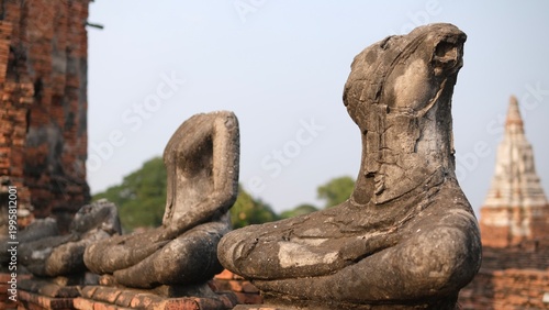  Ayutthaya, Thailand : Close up damaged ancient sandstone Buddha statues at Wat Chaiwatthanaram, the Unesco World Heritage site of Ayutthaya Historical park.