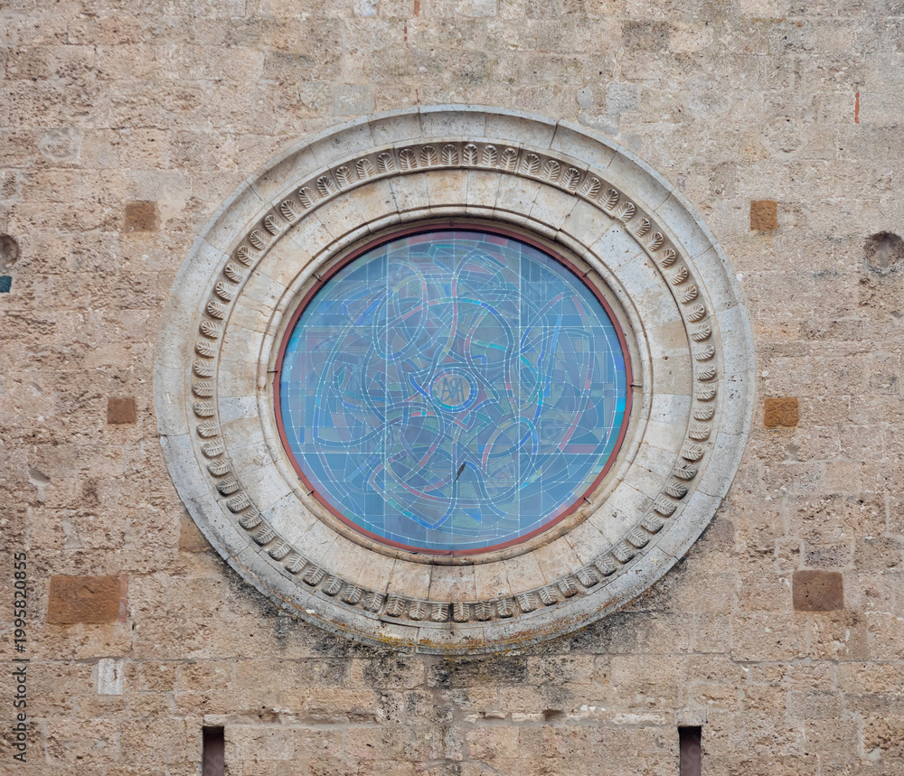 Fototapeta premium Rose window with abstract stained glass, San Gimignano, Italy