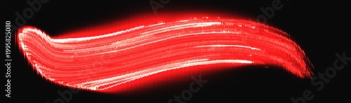 Paint stroke of bright red pigment creates a textured artistic mark isolated against a deep black backdrop to represent creative expression and bold graphic design elements.