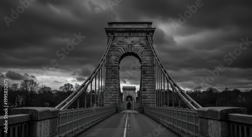 Dramatic suspension bridge in stormy weather.