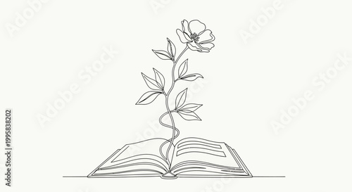 A flower grows out of an open book on a table indoors.