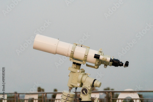 Astronomical telescope on mount under clear sky for stargazing and space observation