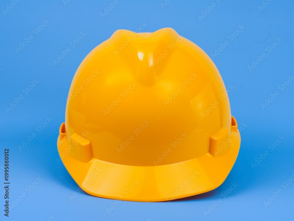 Fototapeta premium Safety hardhat isolated on blue background