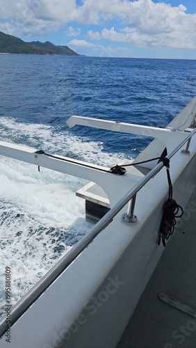 Boat moving on ocean with wake trail, tropical travel and vacation concept, freedom and adventure