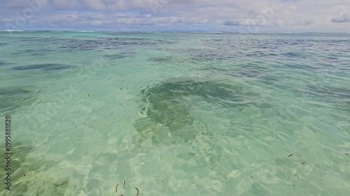 Clear turquoise shallow sea water, tropical beach background, calm ocean surface and vacation concept