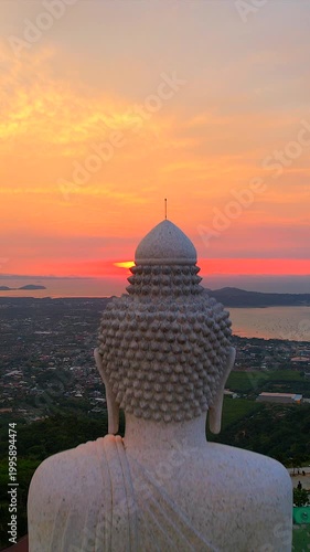 The Big Buddha on the mountaintop, combined with the view of the sunrise in the morning, is a very beautiful view in Phuket province, southern Thailand.