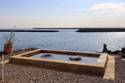 Outdoor foot bath facing the sea in Beppu, Japan.
