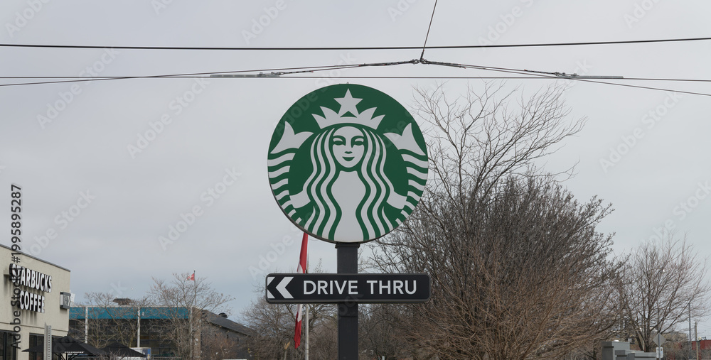 Naklejka premium round pylon sign with Starbucks Coffee Company twin-tailed Siren mascot and Drive Thru located at 23 Leslie St, Toronto