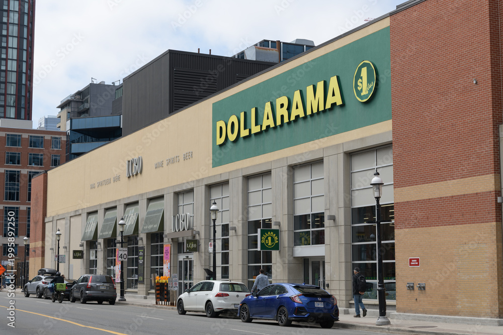 Fototapeta premium perspective view of building and sign of Dollarama, a dollar store chain, located here at 226 Front St E, Toronto