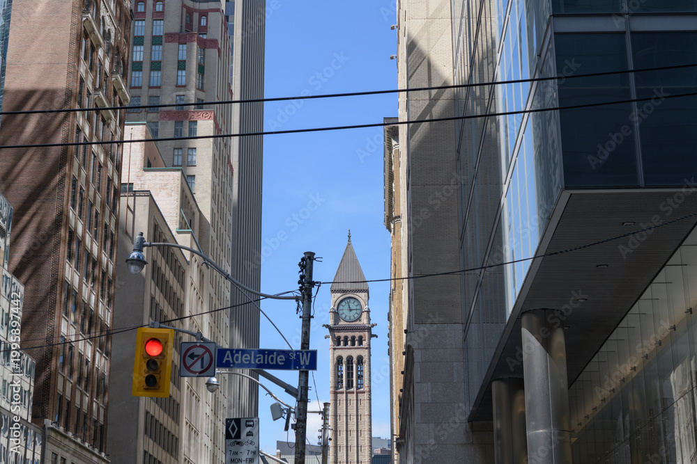 Fototapeta premium looking north on Bay St to bell and clock tower at Old City Hall from Adelaide St W, Toronto