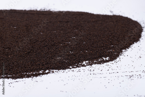 Powdered black tea on a white background