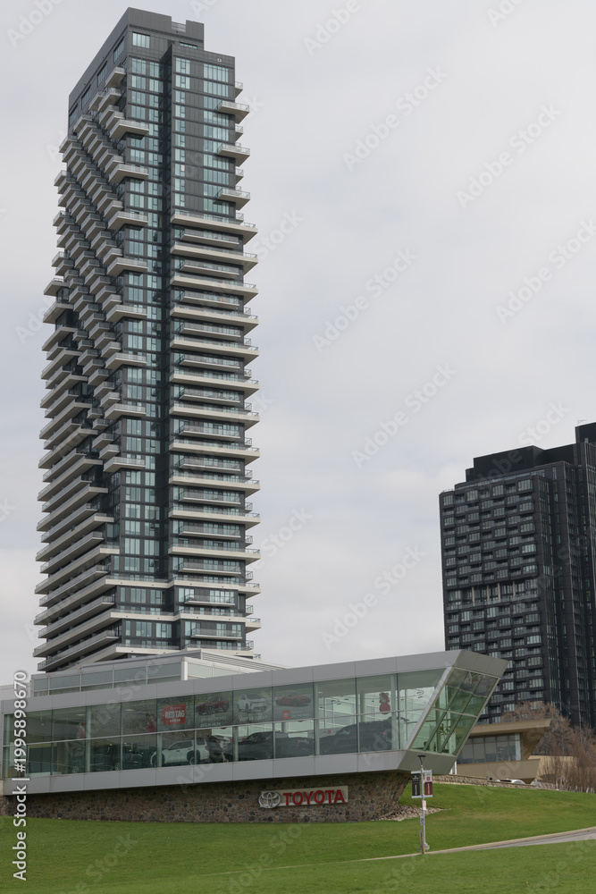 Fototapeta premium wide view of Toyota On the Park, with vehicle display gallery, at 1077 Leslie St (with view of Auberge on the Park Condos), Toronto
