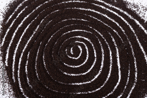 The spiral patterns formed by the black tea powder