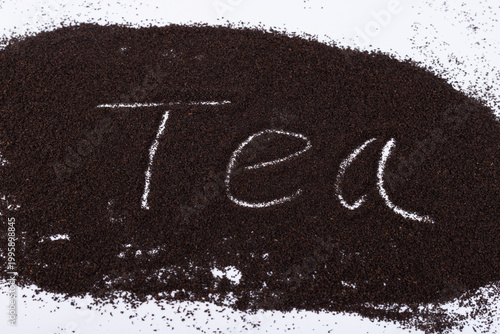 Fotografie Black tea powder on a white background