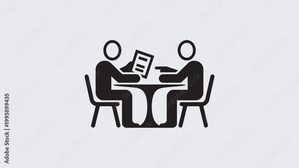Fototapeta premium Two people sitting at a table discussing a document in a meeting