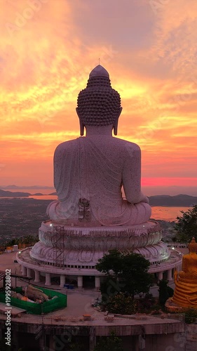 The Big Buddha on the mountaintop, combined with the view of the sunrise in the morning, is a very beautiful view in Phuket province, southern Thailand.