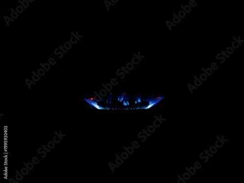 A single gas burner emits a blue flame against a dark background, indicating efficient combustion of gas stove.