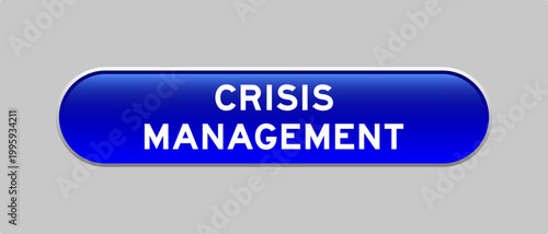 Blue color capsule shape button with word crisis management on gray background