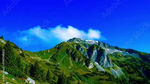 a summer mountain with clear sky and slow clouds 