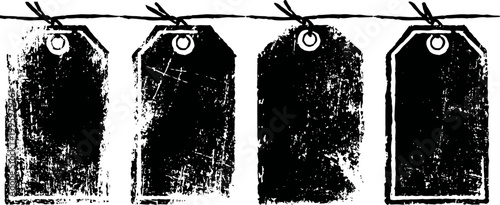 Four vintage blank grunge black tags hanging on twine string with eyelets