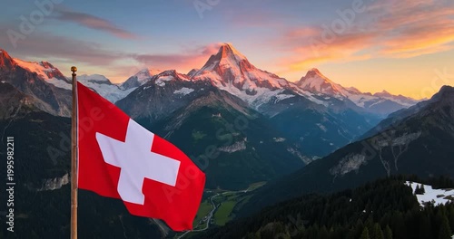 Swiss flag waving in front of the Swiss Alps mountains at sunset