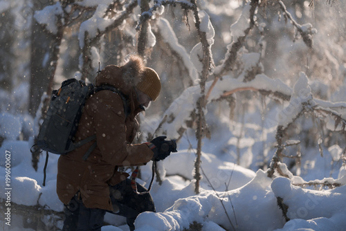 Nature photographer working in a snowy winter forest, exploring and capturing the wilderness.