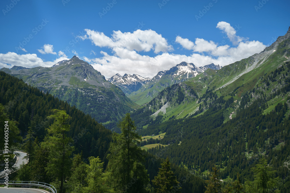 Fototapeta premium Scenic view of the winding Maloja Pass road with hairpin turns in the Swiss Alps, perfect for road trip themes