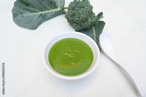 Broccoli soup on white background. It is just as nutritious as it is visually appealing. Crafted into a perfectly smooth, silky, and emerald-green puree, it delivers the fresh taste of green vegetable
