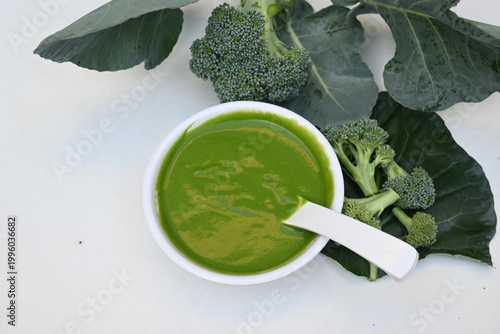 Broccoli soup on white background. It is just as nutritious as it is visually appealing. Crafted into a perfectly smooth, silky, and emerald-green puree, it delivers the fresh taste of green vegetable