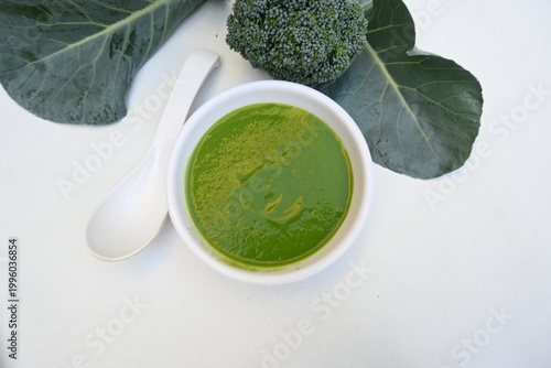 Broccoli soup on white background. It is just as nutritious as it is visually appealing. Crafted into a perfectly smooth, silky, and emerald-green puree, it delivers the fresh taste of green vegetable