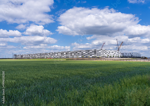 Exterior shot of a data center located in Hutto, Texas. under construction besides rolling fields near Austin
