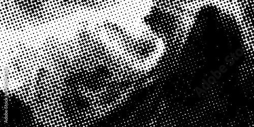Abstract black and white halftone texture with dense dotted pattern and grunge dispersion effect, modern vector background for bold print, digital, and creative projects