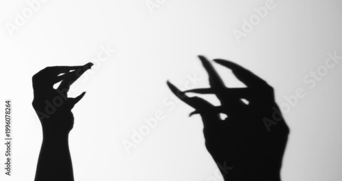 Shadow of a zombie hand on white background
