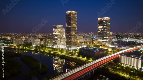 A modern metropolitan city at night, aerial view of illuminated skyscrapers and highway traffic