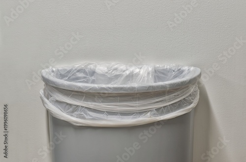 Canvas-taulu Gray trashcan partial with trash bin liner by white plain wall with copy space