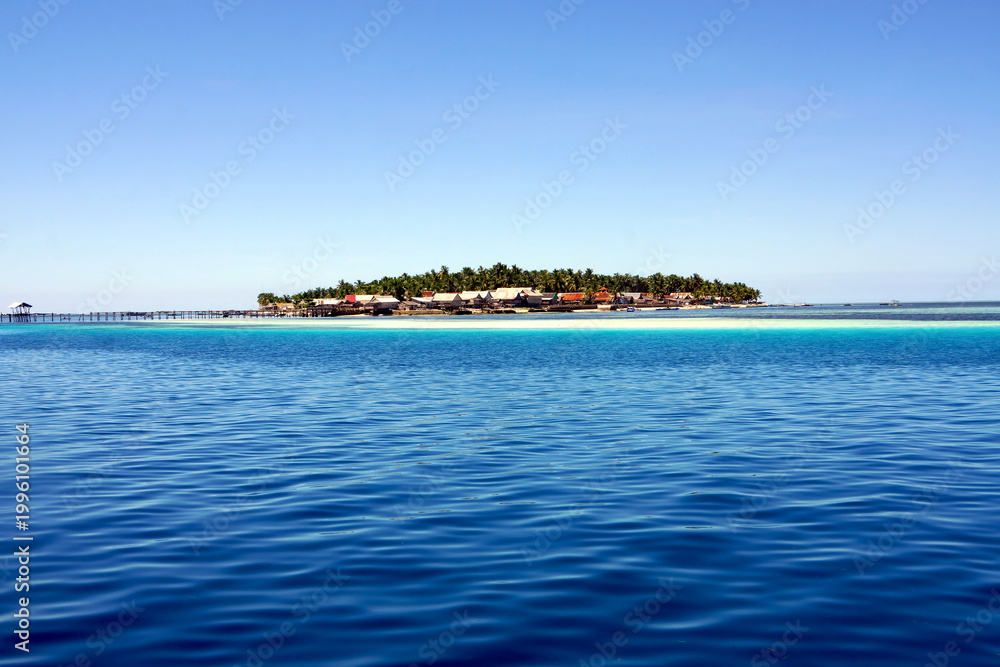 Fototapeta premium tropical island with blue sky and sea, big tarupa island, Indonesia