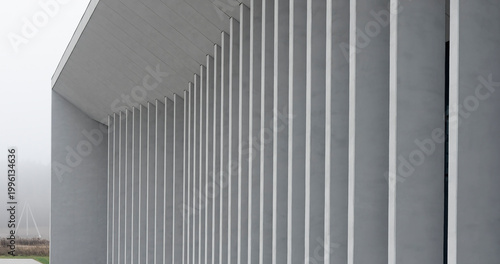 Bild auf Leinwand Modern gray building facade with tall vertical columns