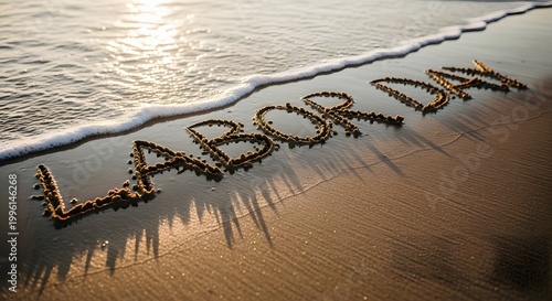 Labor day beach message celebrating workers with 'labor day' written in sand
