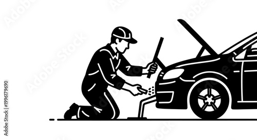 Mechanic kneeling beside a car with the hood up