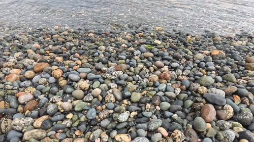 Haines - Alaska - USA - April 21, 2024 - Close up of pebbles smoothly rounded by water, densely covering the shoreline of Chilkat Inlet in Southest Alaska near Haines.
