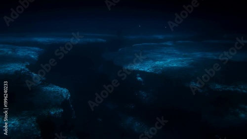 Underwater view of a deep ocean trench illuminated by soft blue light. A mesmerizing glimpse into the mysterious depths of the ocean ecosystem