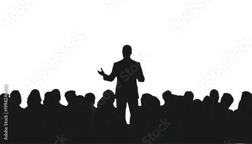 Speaker stands before a large audience to deliver an important presentation during a business event.