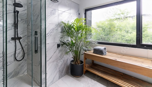 modern spa shower lifestyle image white and gray marble tile shower with glass door and matte black hardware bamboo shower bench and plants