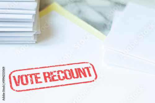 Vote recount stamp on a sheet with ballot papers around it, concept of an election review following disputed results