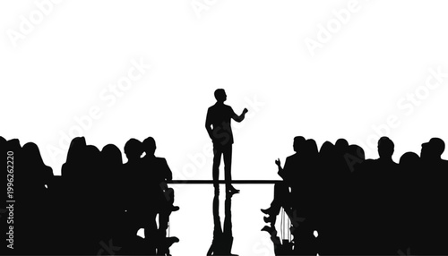 Speaker stands on a stage to address a large crowd of attentive people during a formal conference.
