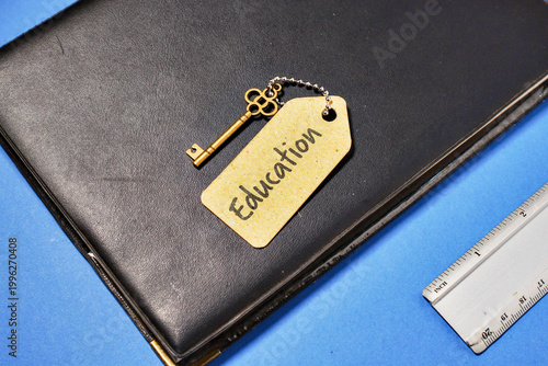 Education Key to Success Concept on Black Book with Ruler