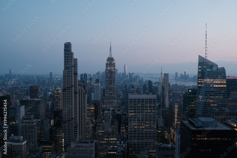 Fototapeta premium Manhattan skyline at dusk with Empire State Building, aerial cityscape, blue hour, New York City travel and urban architecture photography.