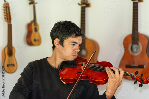 Man playing violin in home studio